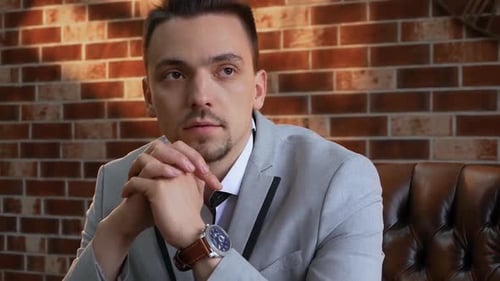 Thoughtful Young Adult Man Wearing a Suit