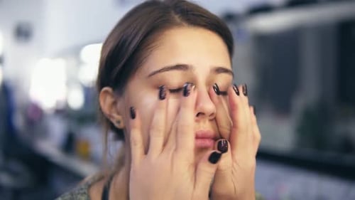 Woman Applies Facial Cream in Close-Up Shot