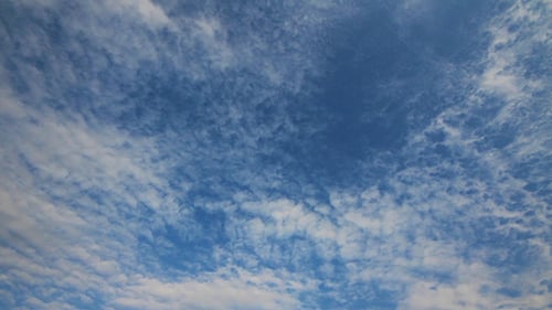 Fluffy Clouds Moving Slowly Against Blue Sky