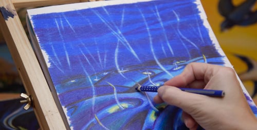 Artist Drawing on Canvas with Blue Pencil