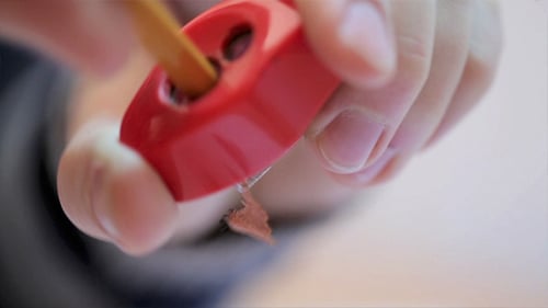Sharpening a Pencil with Red Pencil Sharpener