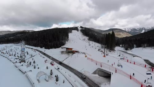 Aerial View on Ski Slopes with Skiers and Ski Lifts on Ski Resort in Winter