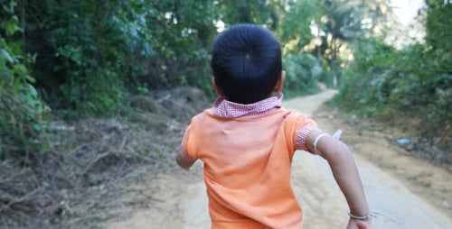 Poor Kid Running On Dirt Road