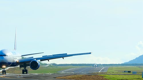 Passenger Planes on Runway Awaiting Takeoff on Sunny Day