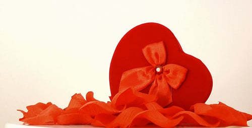 Heart Shaped Gift with Red Rose Petals