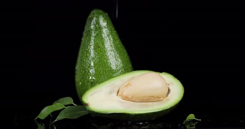 Rain Drops Falling on Fresh Avocado.
