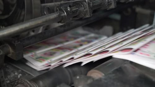 Printed Newspapers are Moved Along Conveyor