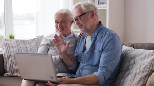 Senior Couple Video Calling with Laptop Computer