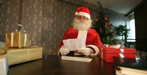 Santa Claus Reads Christmas Letter with Gifts