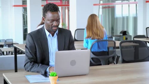 African American Manager Tell Great News Works in Open Space Office Worker in Start Up Company