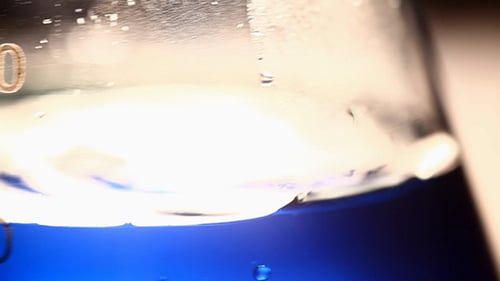 Blue Liquid Shaking in a Glass Beaker