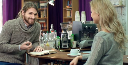 Man and Woman Chatting Over Coffee at Counter