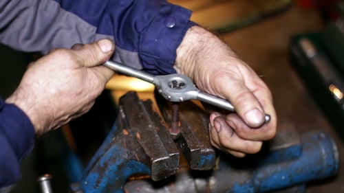 Tradesman Tightening Bolt in Vice