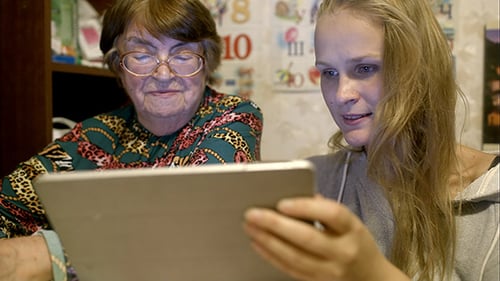Grandmother and Young Woman Enjoying Tablet Together