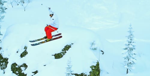 Skier Performing Jump on Snowy Winter Mountain