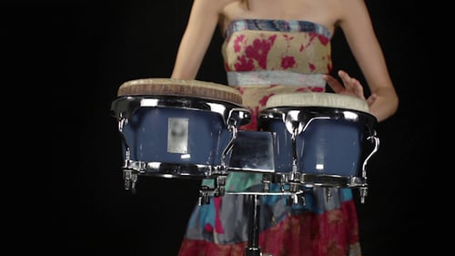 Woman Playing Bongos in a Studio