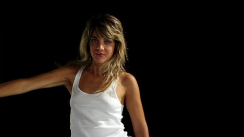 Woman Dancing Expressively Against Black Background