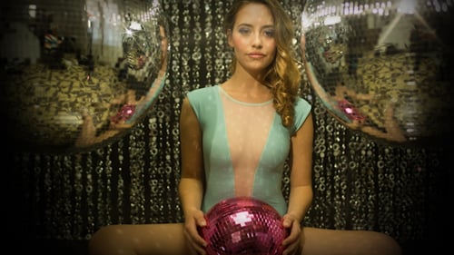 Glamorous Woman Posing with Disco Ball Indoors