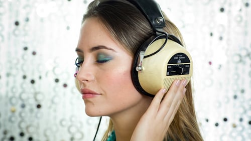 Woman Listening to Music on Vintage Headphones