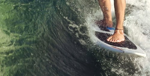 Board Gliding Across Shimmering Ocean Waters