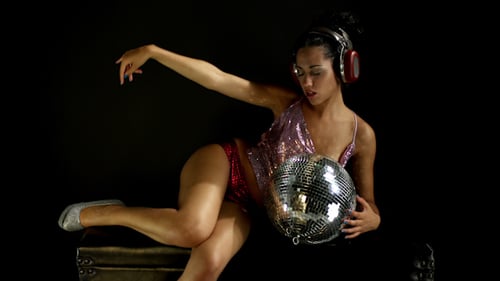 Young Woman with Disco Ball Listening to Music