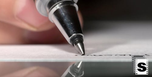 Hand Writes Elegant Signature with Chrome Pen Close-Up
