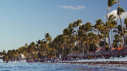 Tropical Resort With People On The Beach And Boats