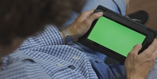 Adult Using Tablet with Green Screen Display
