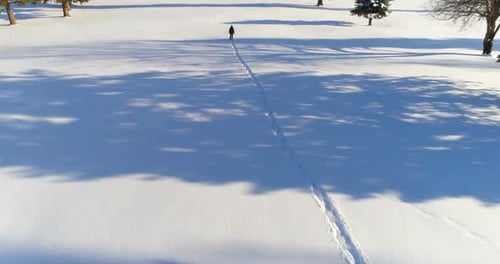Hiker walking on a snowy landscape 4k