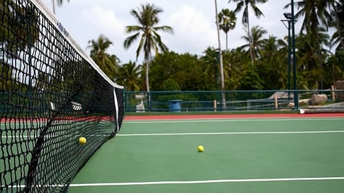 Tennis Balls Bouncing on Tropical Court