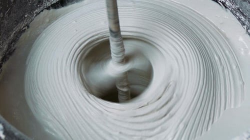 Mixing Plaster In a Bucket Close Up