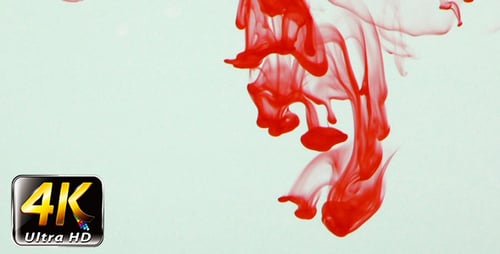 Red Ink Swirling Abstractly in Water