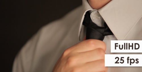 Man Tying a Tie in Close Up