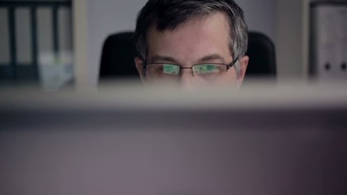 Businessman Works in front of his Computer