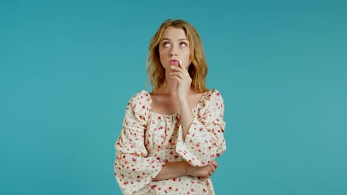 Woman Thinking Deeply in Front of Blue Background