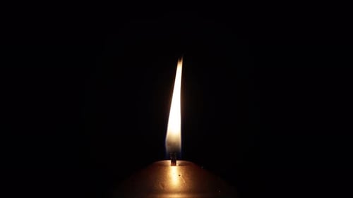 Single Big Gold Candle Closeup Candle Flame on Black Background Footage
