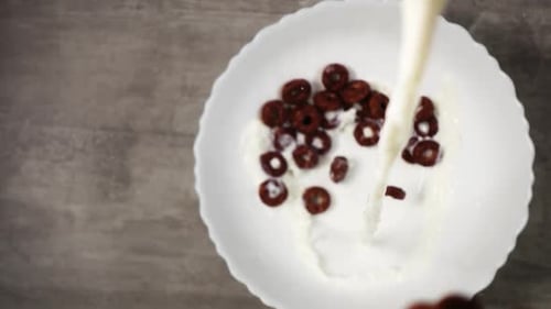 Chocolate Cereal Rings and Milk being Poured in Bowl