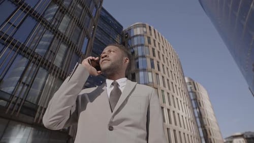Afro Man Talking on Phone in Metropolis