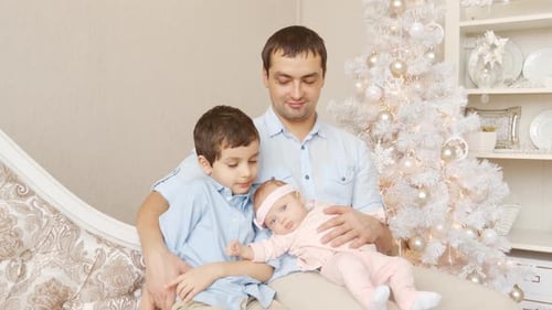 Loving Father with Children by Christmas Tree
