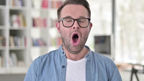 Man With Glasses Yawns in His Home