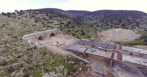 Aerial footage of a large scale highway construction project with tunnels and bridges