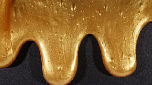 Golden Ooze Flowing on Black Surface