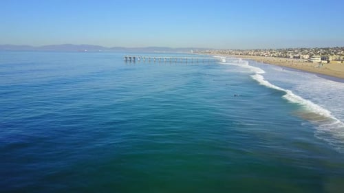 Aerial drone uav view of a pier over the beach and ocean.