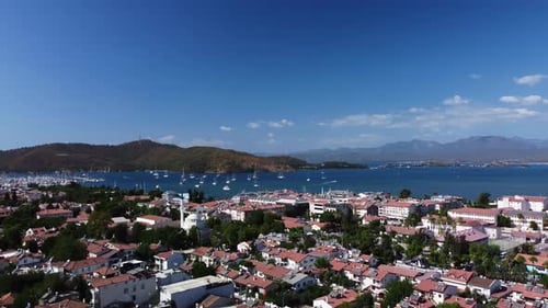 Landscape of Fethiye Harbor with Luxury Yachts and Ships Swimming Among Mountain Ridge and Coastline