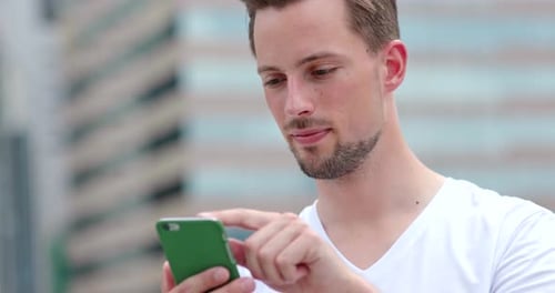 Caucasian young man use of mobile phone