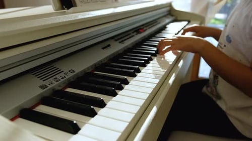 Child Plays Piano in a Bright Home