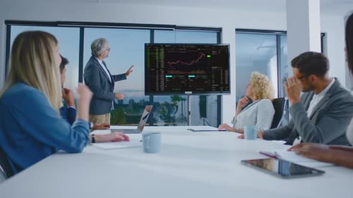 Business Team Meeting with Presentation in Modern Office