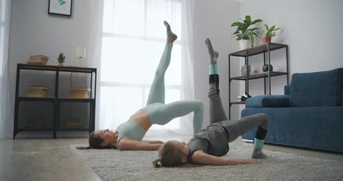 Woman and Child Exercising Together in Living Room