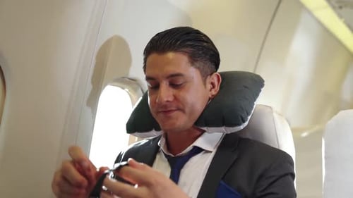 Man Puts on Sleep Mask on Airplane