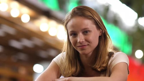 Pretty thoughtful young woman with blond hair looking smiling